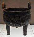 Bronze round tripod with animal mask decoration